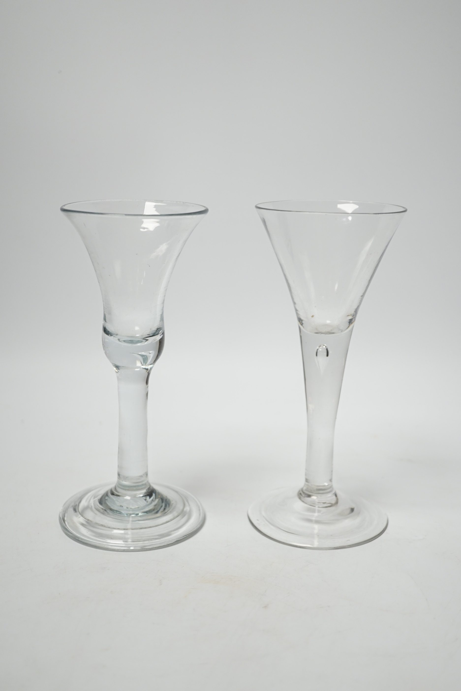 Two Georgian wine glasses, both with plain stems one with tear, the other with bell-shaped bowl and folded foot, the other with trumpet-shaped bowl, both 16.5cm